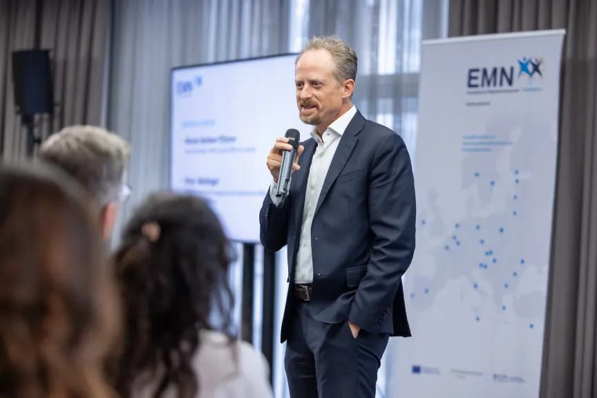 EMN-Conference - Picture of Peter Webinger holding opening remarks on stage